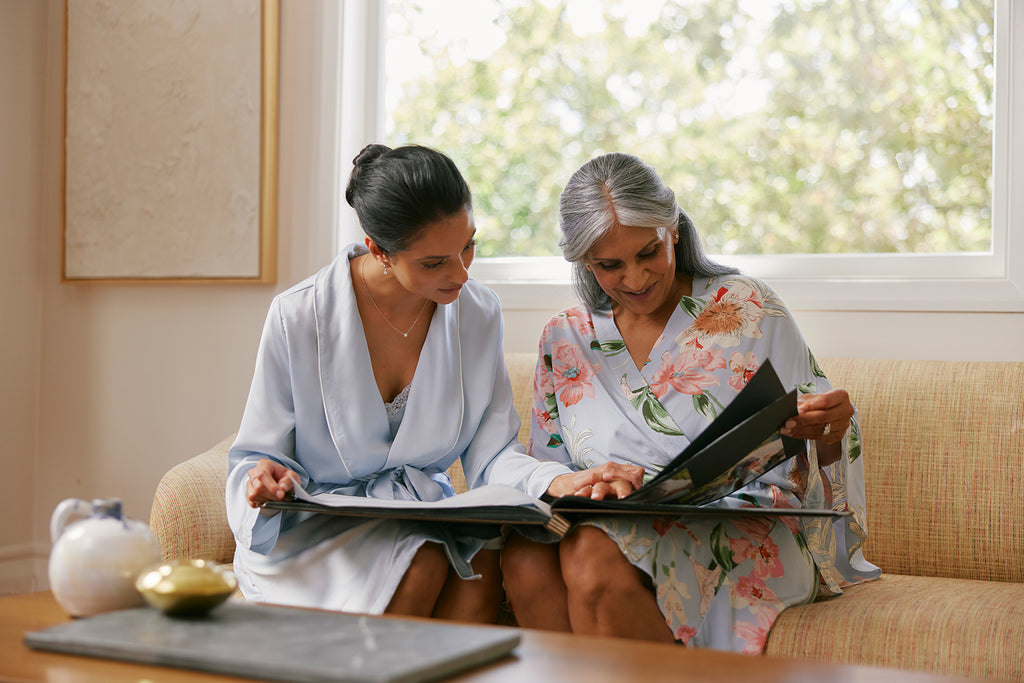 Mother and daughter looking at photo album