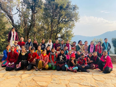 A group of young girls smiling who have been supported by Action Village India