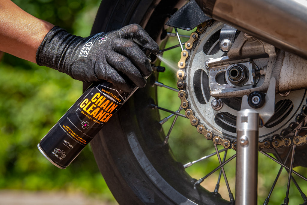 Applying Muc-Off Chain Cleaner to motorcycle