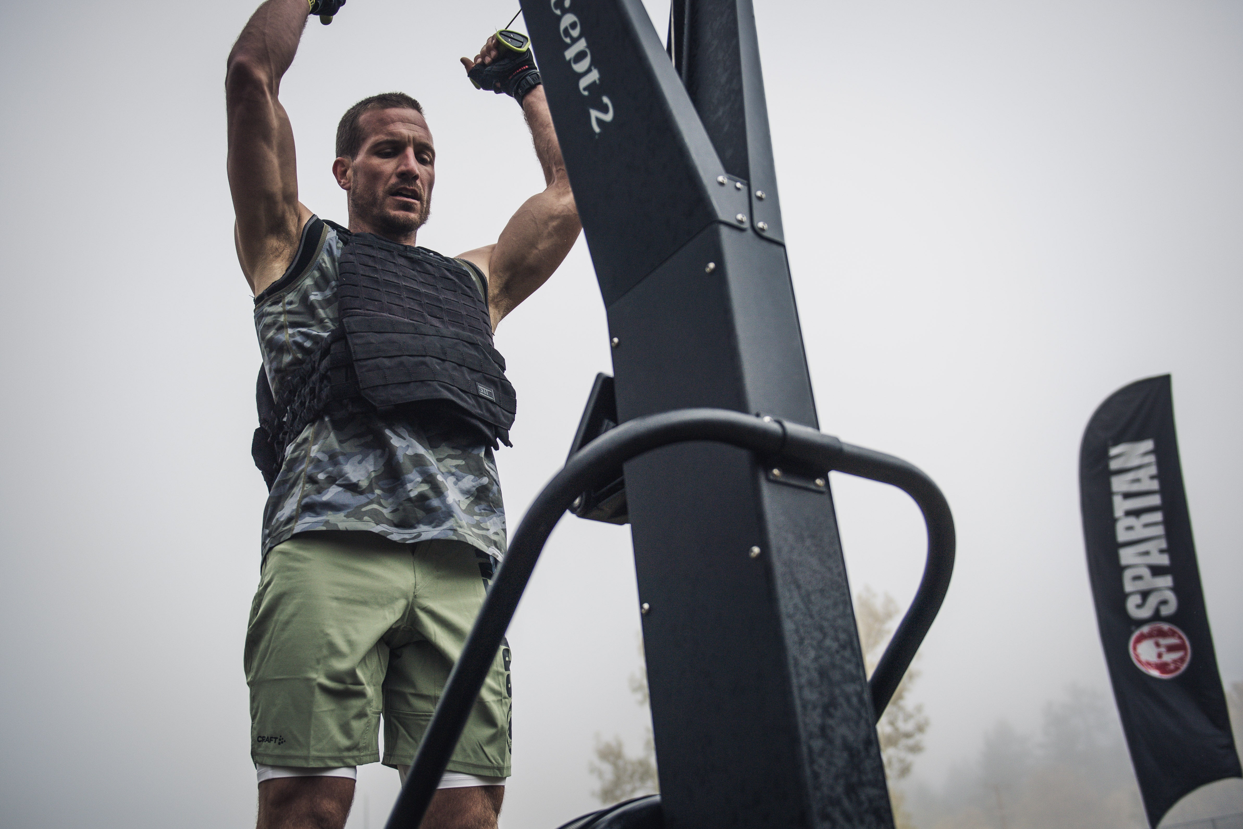 a spartan racer working out in a weighted vest