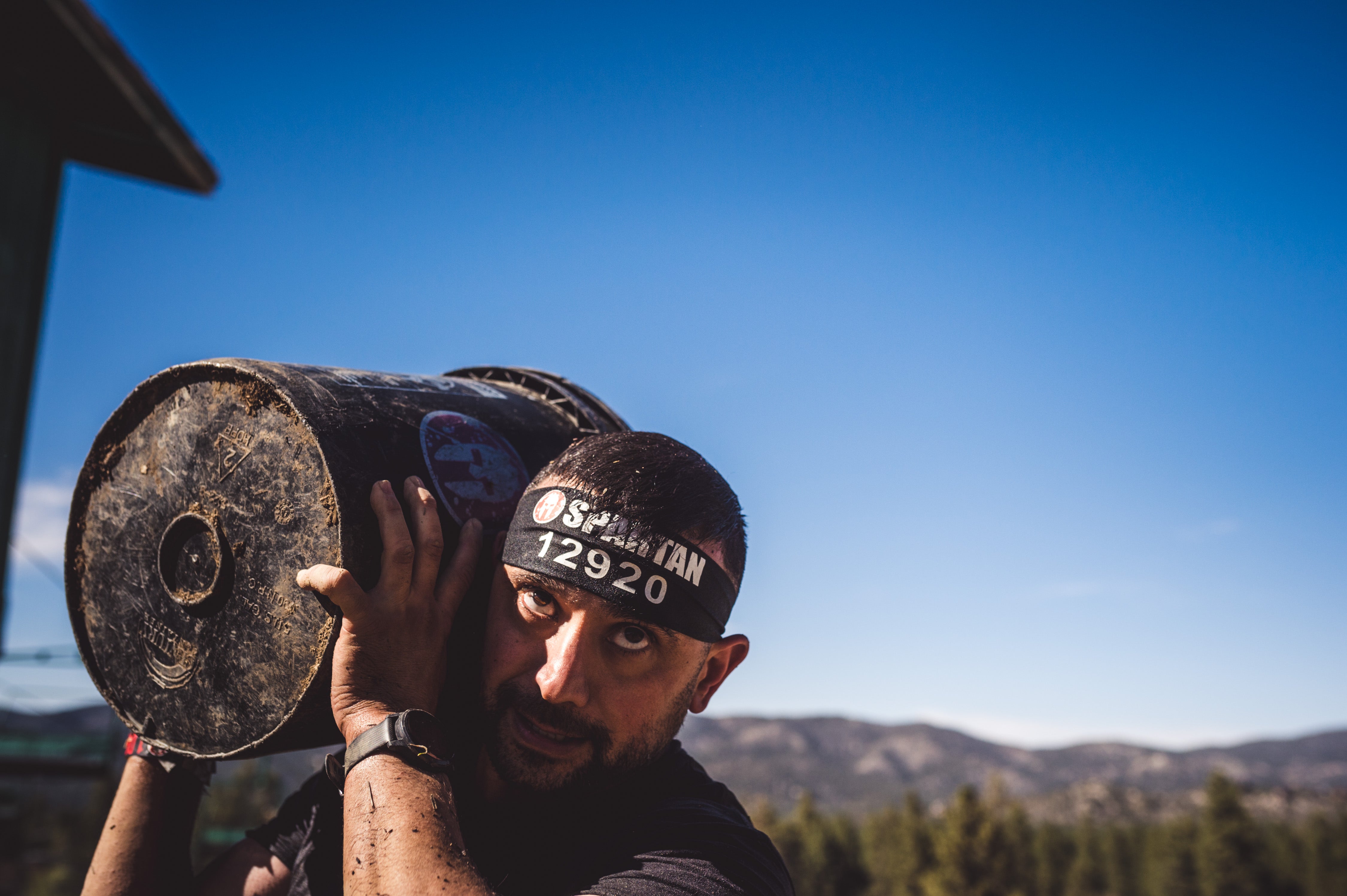 a Spartan racer looking ahead while doing the Bucket Carry obstacle