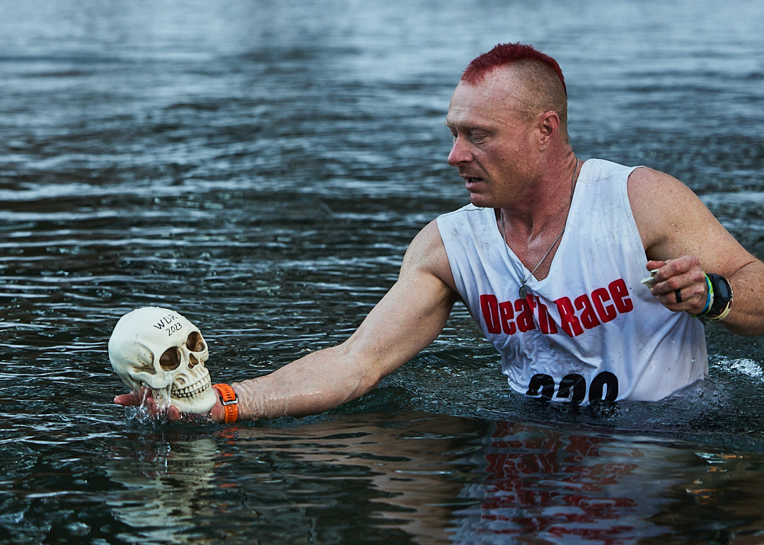 a spartan winter death race finisher pulling his skull out of the pond