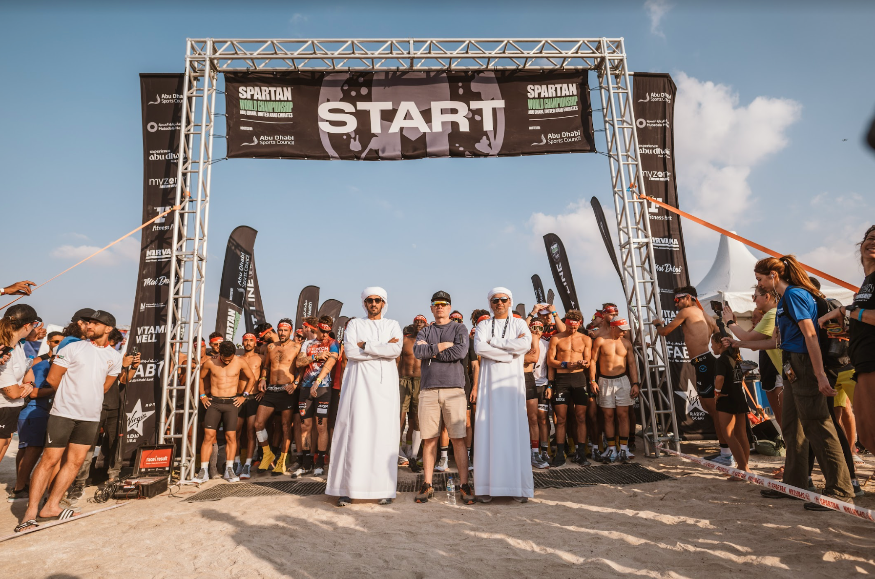 spartan ceo joe de sena and racers standing at the start line of the spartan world championship