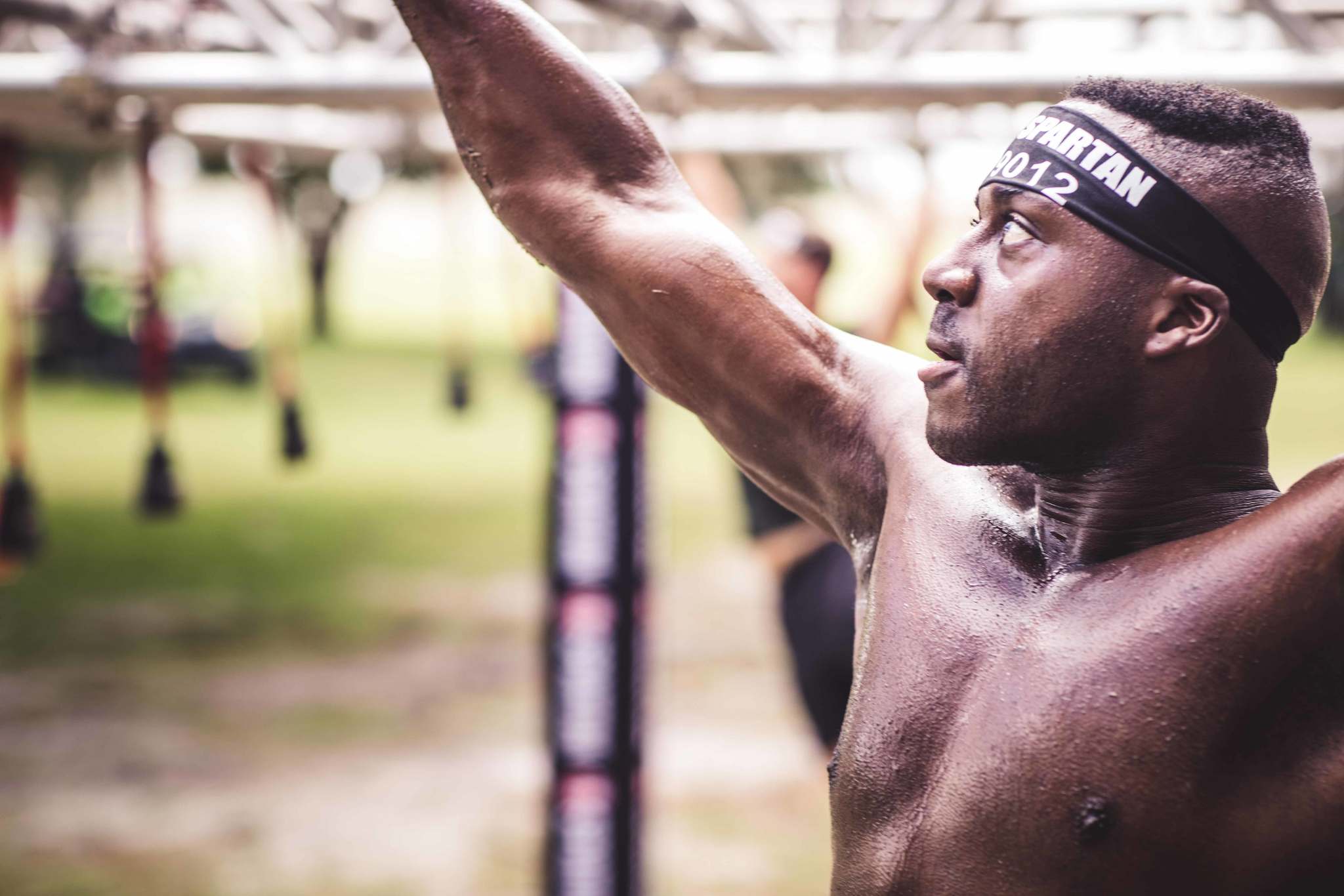 A Spartan racer is able to swing safely on the Monkey Bars and Multi-Rig, having prepared with exercises for IT band, ankle sprains, and shoulder mobility.