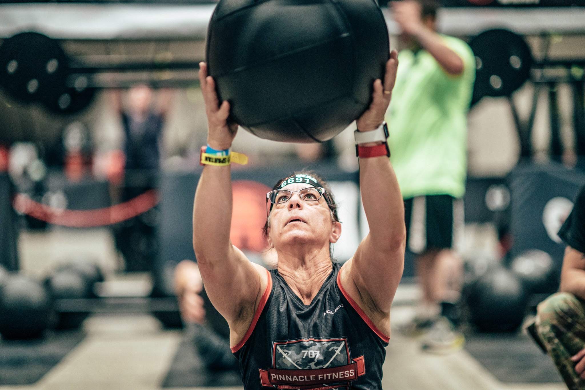 a deka fit racer throwing a medicine ball