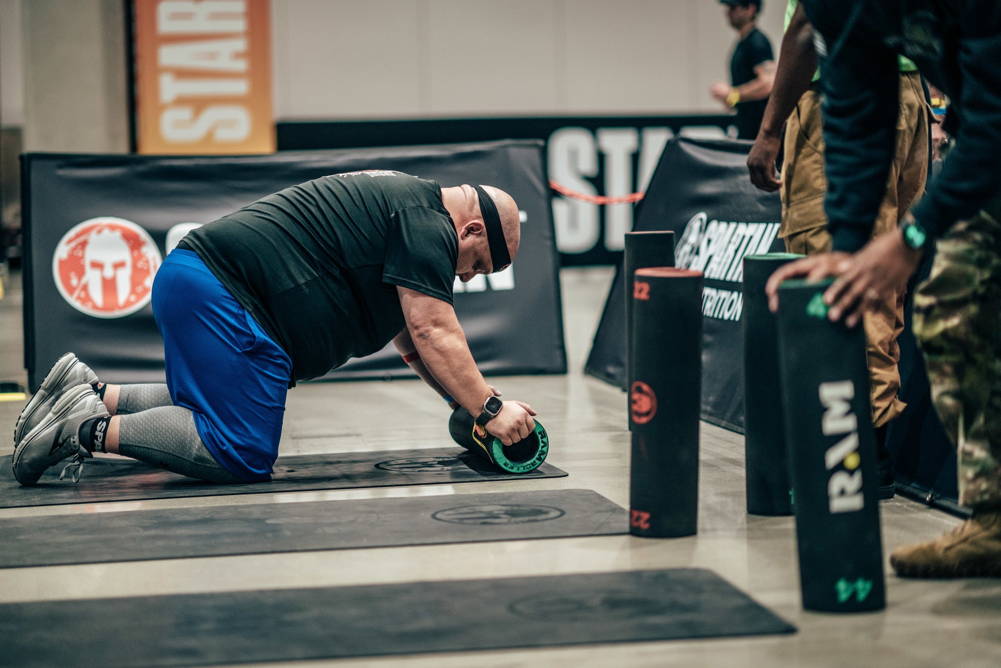 a deka fit racer doing weighted RAM burpees