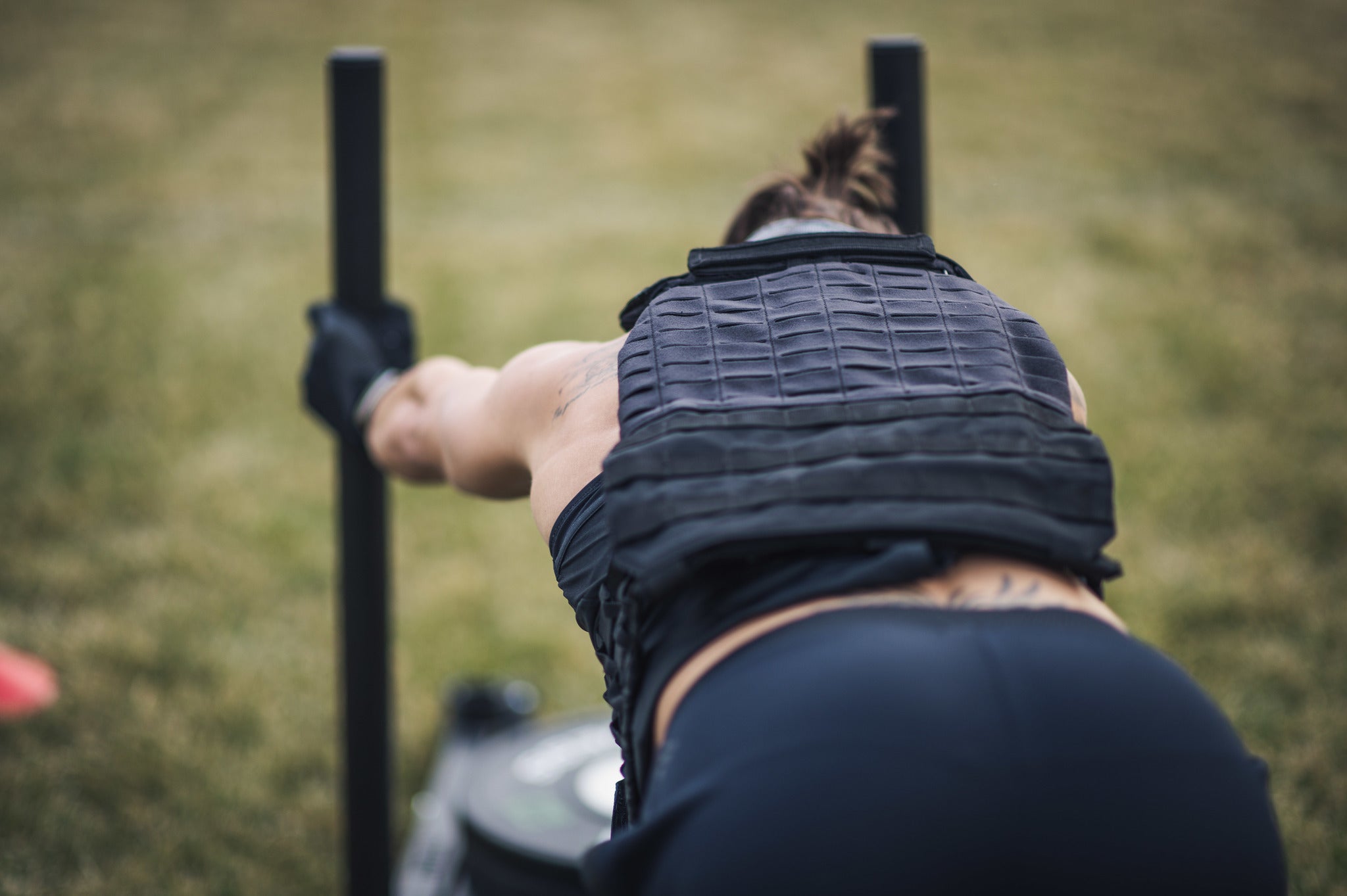 an athlete competing in a makeshift CrossFit Games in a backyard CrossFit gym