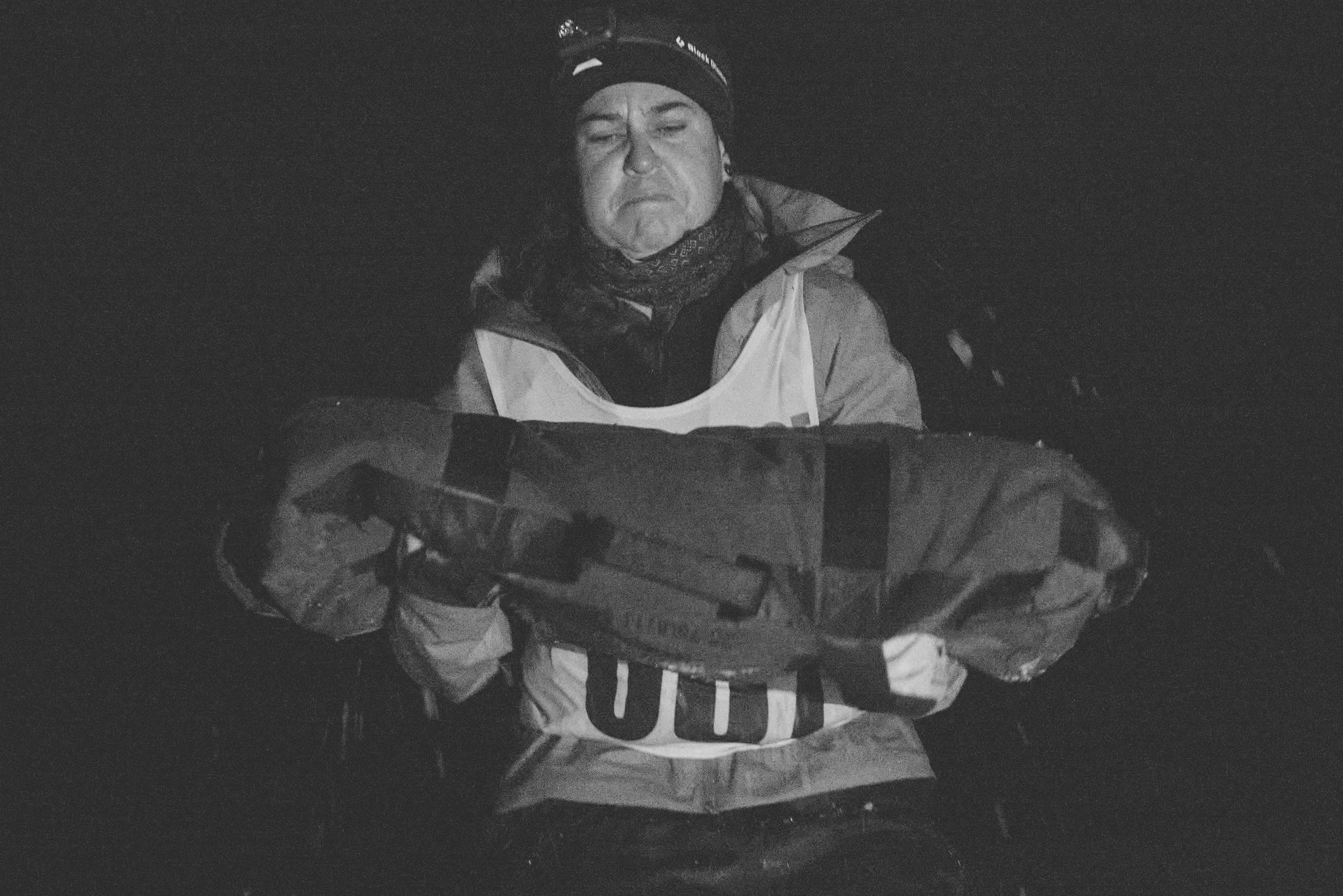 a woman carrying a very heavy sandbag