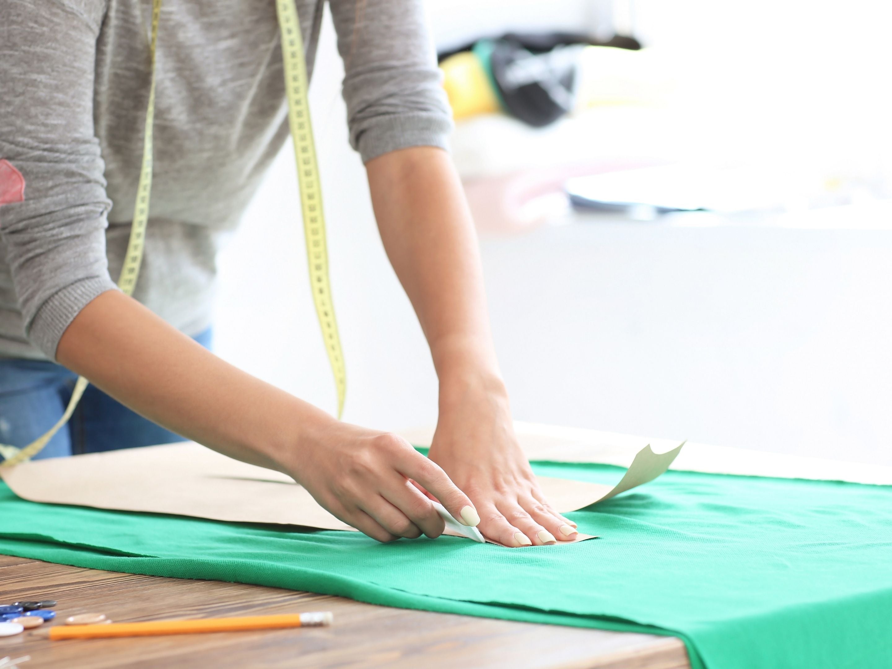 Sewist Cutting Out Fabric With a Pattern