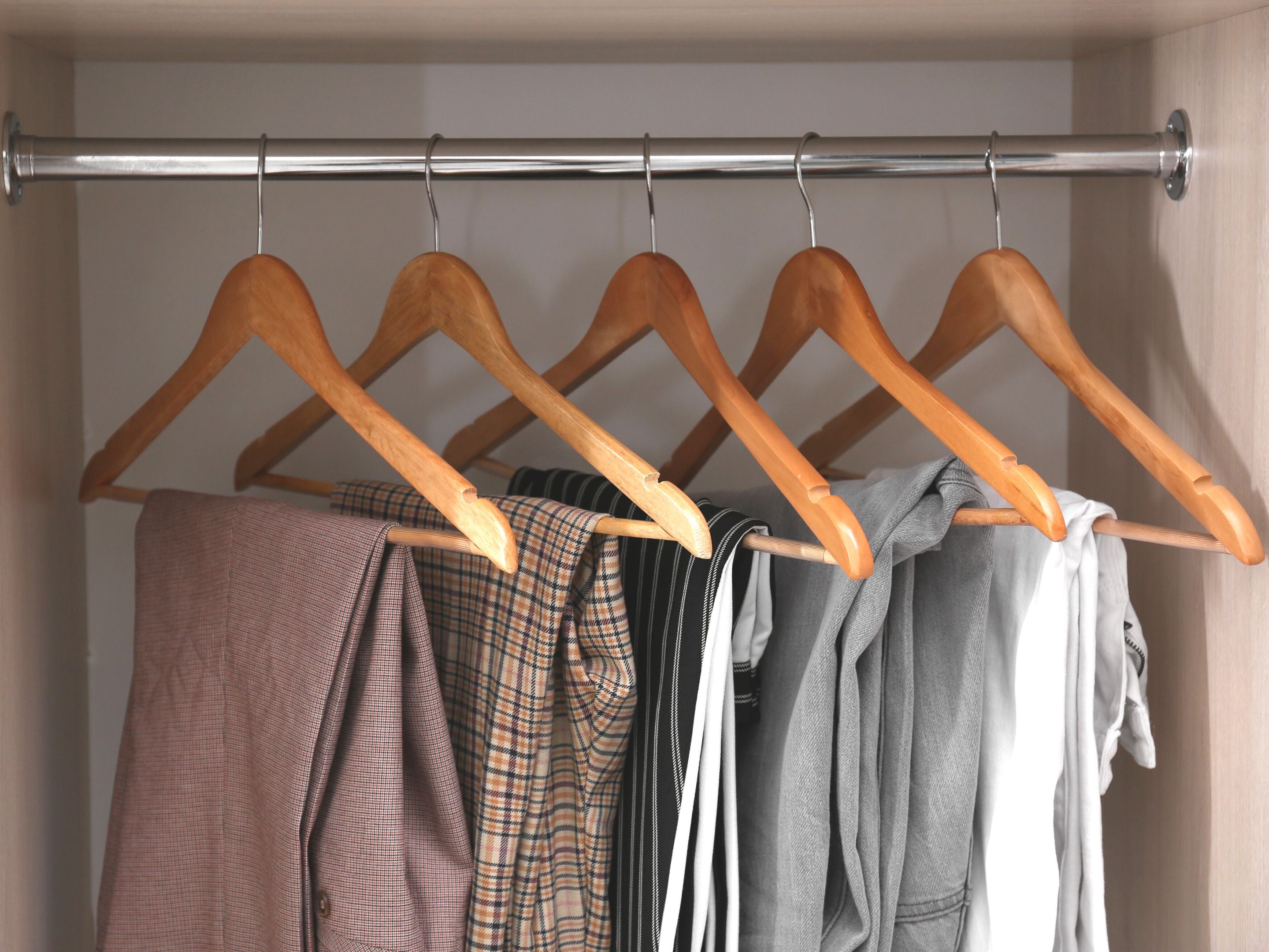 Variety of pants hanging in closet 