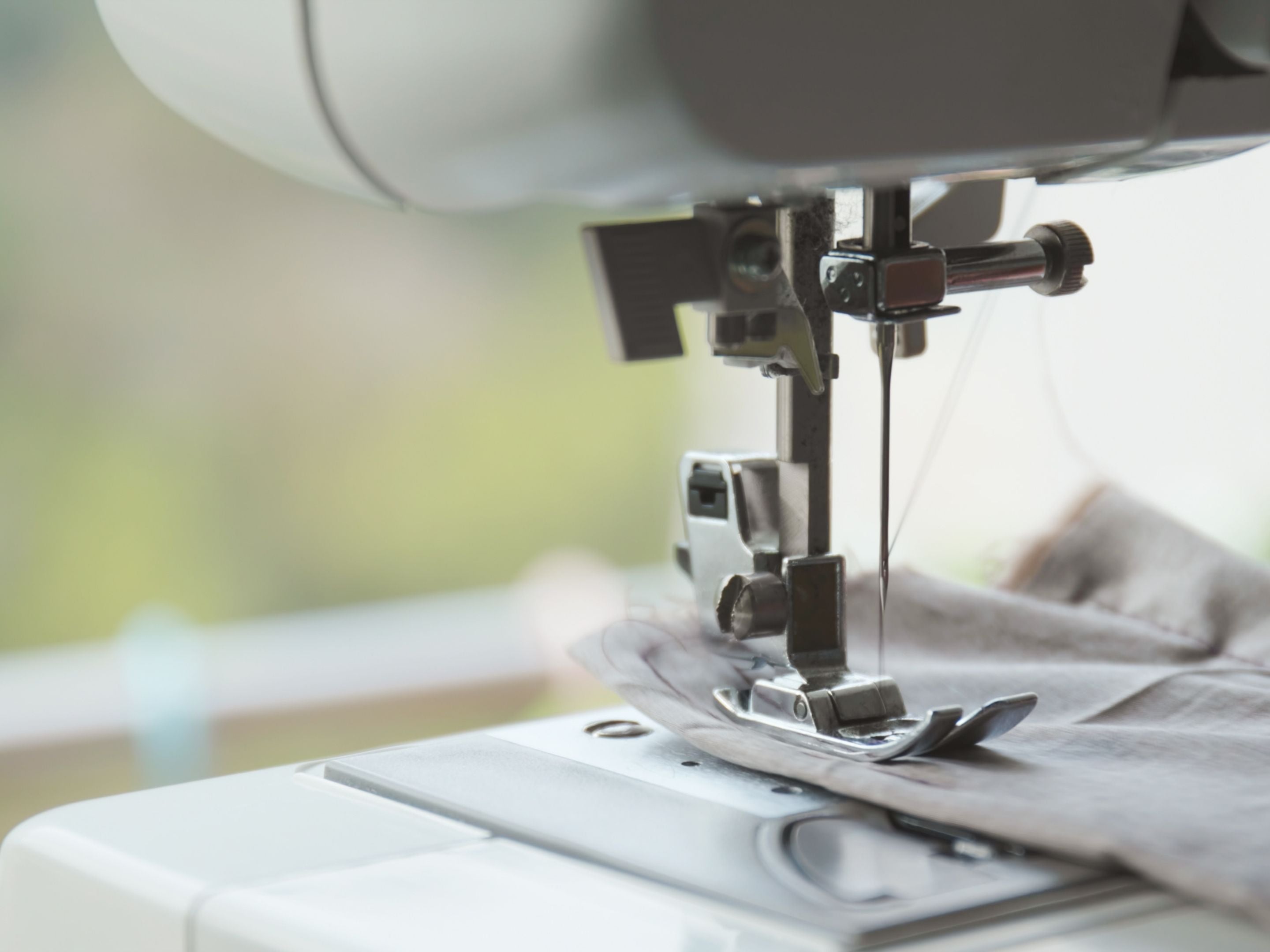 Close Up View of Sewing Machine Needle Thread and Foot