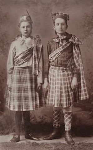 Antique photograph of two girls in Highland dance tartan.