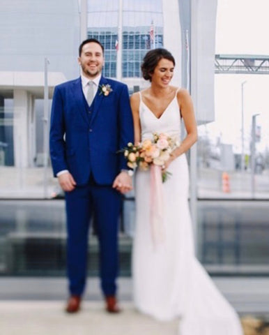 Married couple standing on a rooftop with skyline in the background and silk ribbon by The Lesser Bear