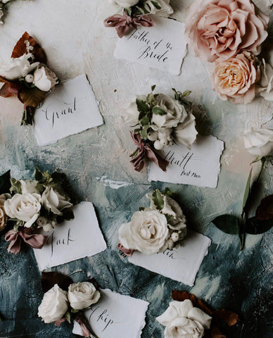 Florals and place cards with silk ribbon by The Lesser Bear