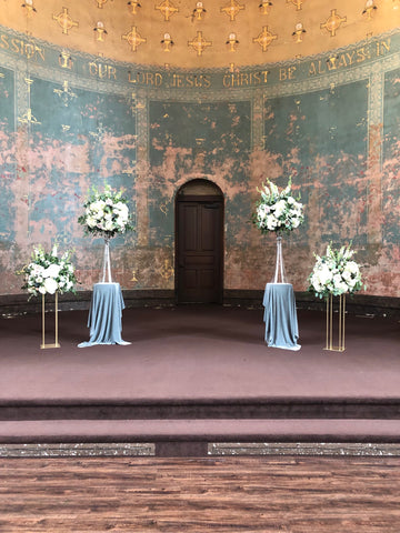 Alter with large floral arrangements on Velvet covered pedestals 