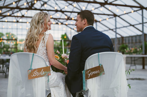 Bride and Groom Signs hanging on chair backs designed by Auburn and Ivory with silk ribbon by The Lesser Bear photo by Ashley West Photo