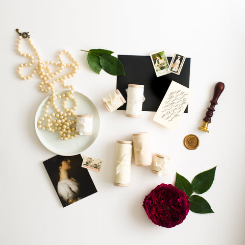 Flat lay of white silk ribbon by The Lesser Bear styled by Auburn and Ivory Creative and Photographed by Maria Siriano