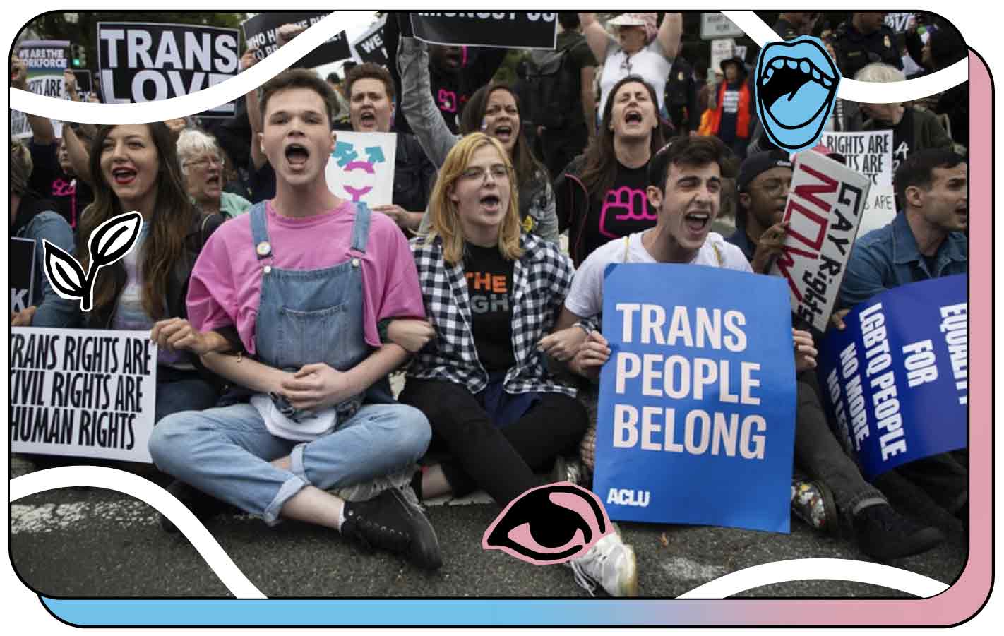 Crowd holding signs at a rally. One sign reads "Trans People Belong."