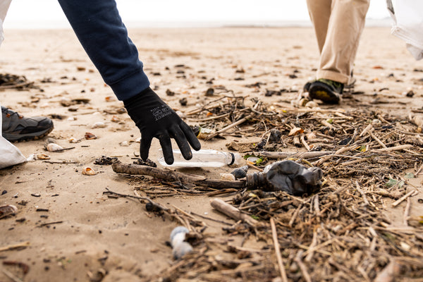 Litter collecting with SAS on beach. Picking up rubbish and plastic