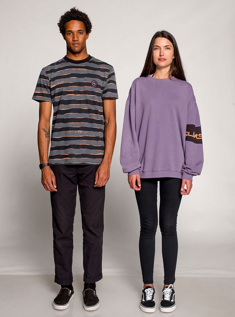 Man wearing a grey tshirt with black stripes and a girl wearing a purple sweater