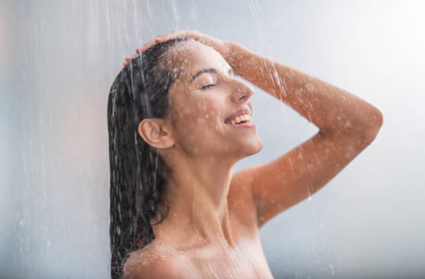 happy woman taking shower