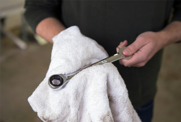 man holding a tool for fixing showerhead