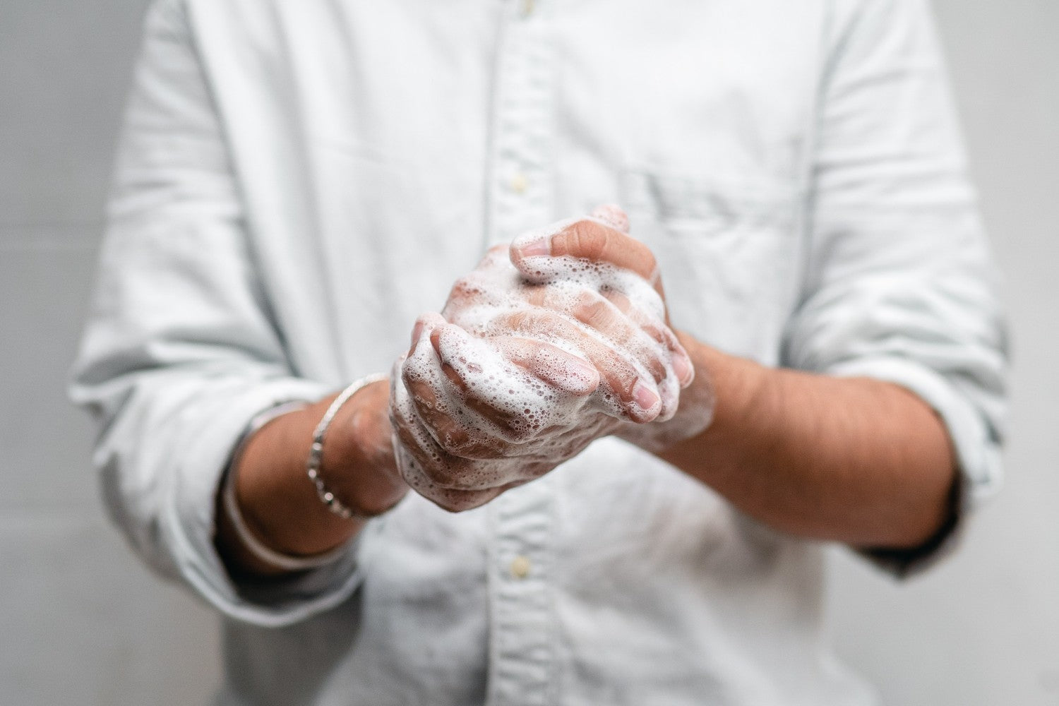 person washing hands with soap