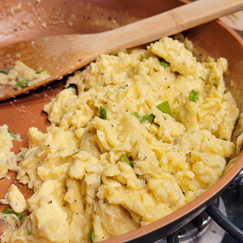 Scrambled Eggs with ground pepper, salt, and green onion.