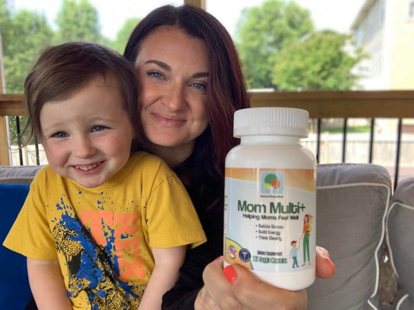 Mom with bottle of Mom Multi+ womens vitamin and her son