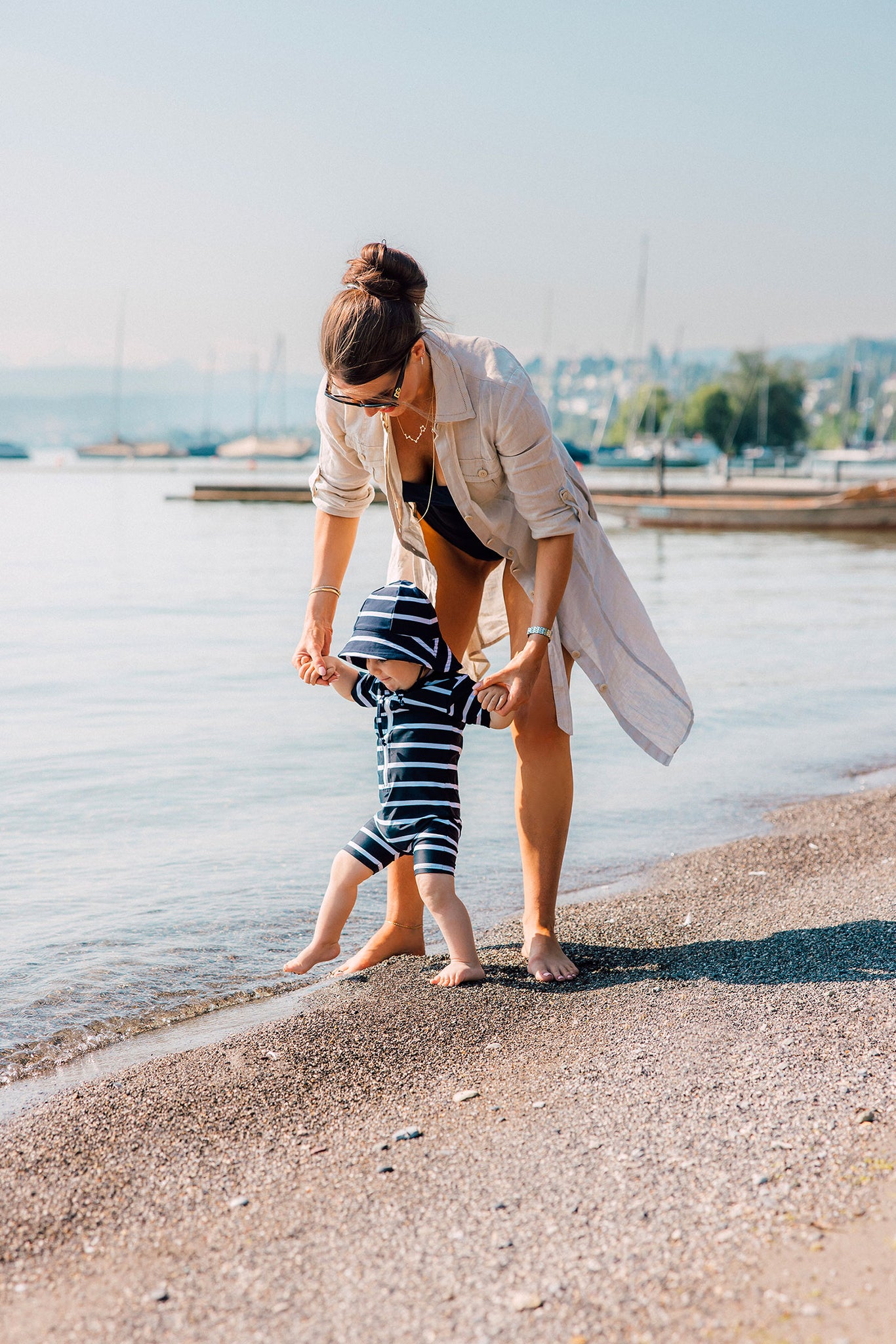 Mami Sohn am Strand in dem Sommer Urlaub UV SChutz