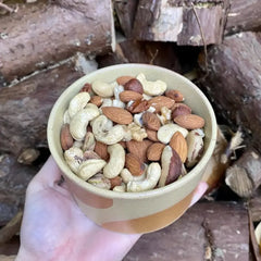 Variety of raw nuts including almonds, pistachios, and macadamia nuts