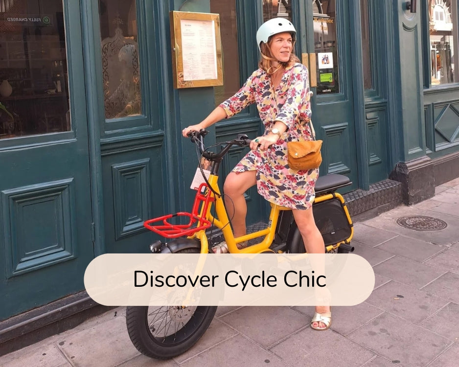 Discover Cycle Chic: Photo of a caucasian woman wearing a dress and posing with a yellow bicycle