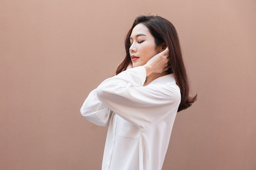 Young asian woman wearing a big white shirt