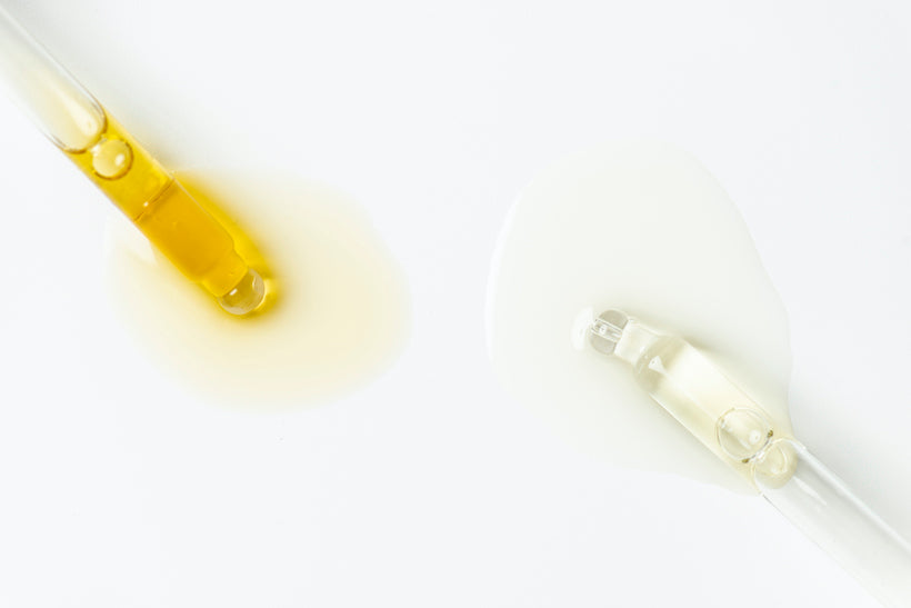 Two beauty serum pipettes on pure white background. 