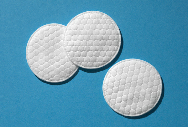 Three textured cotton pads on blue background