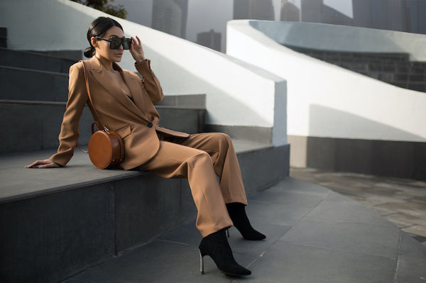 Stylish woman sitting on stairs