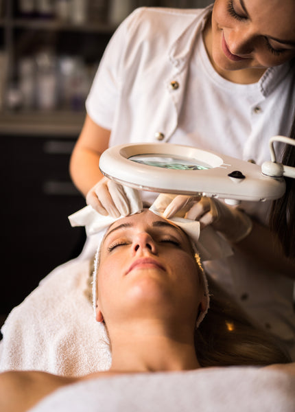 Esthetician doing extractions to a client