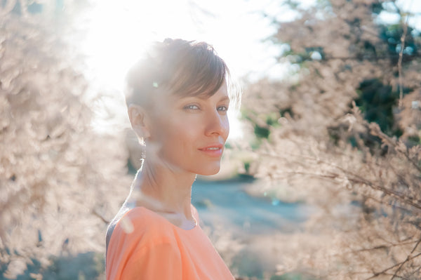 Short hair woman wearing orange blouse in the park (autumn feel)