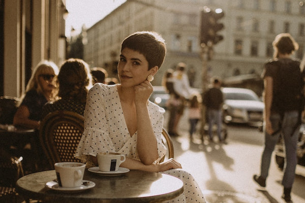 Short haired woman sitting at a cafe 