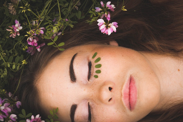 Woman's head resting on flowers