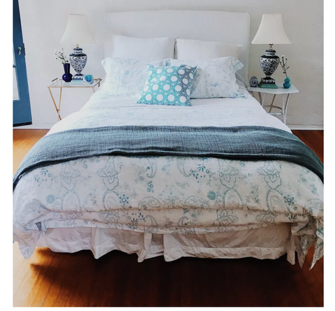 a blue and white bed in a bedroom