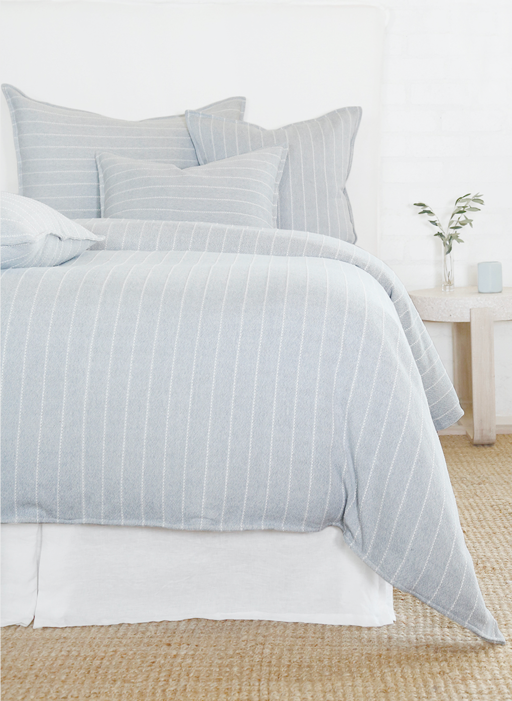 Light blue striped bedding on a bed