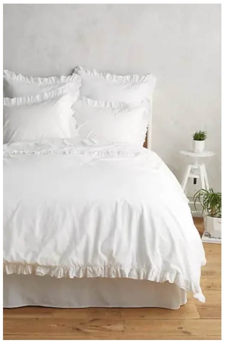 white ruffle bed sheets on a bed