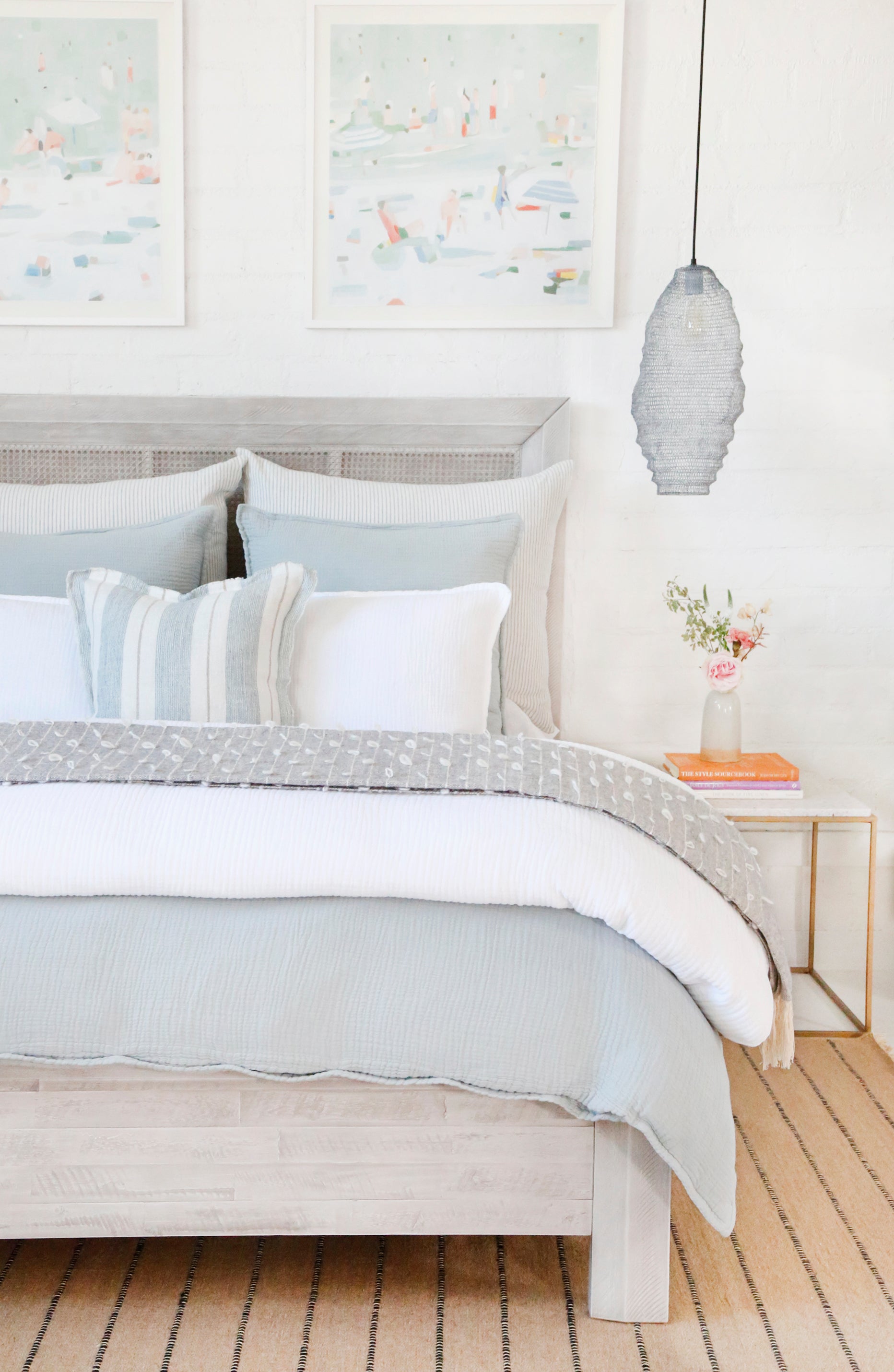 blue and white bedding on bed, lots of pillows