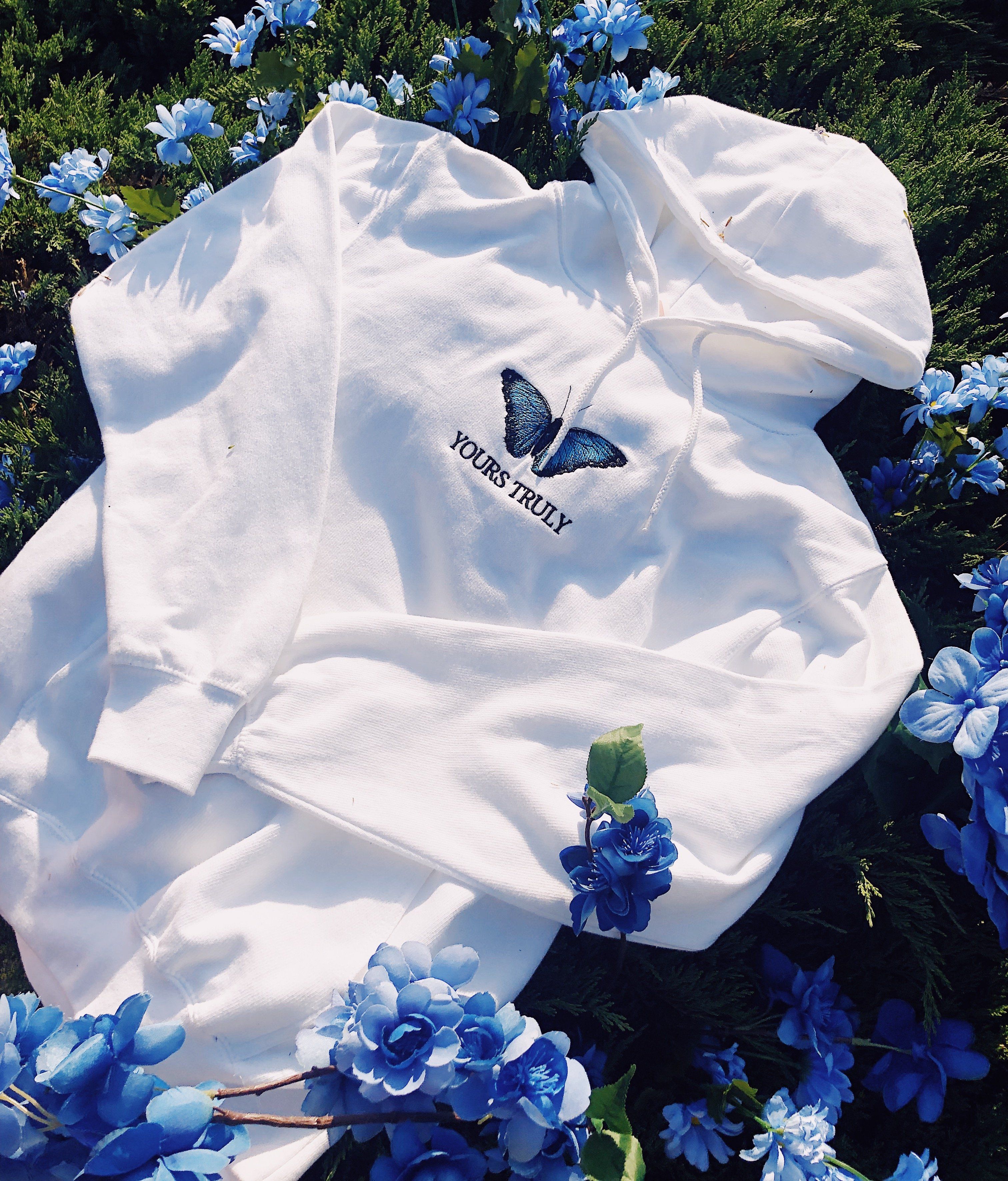 white hoodie with blue butterfly