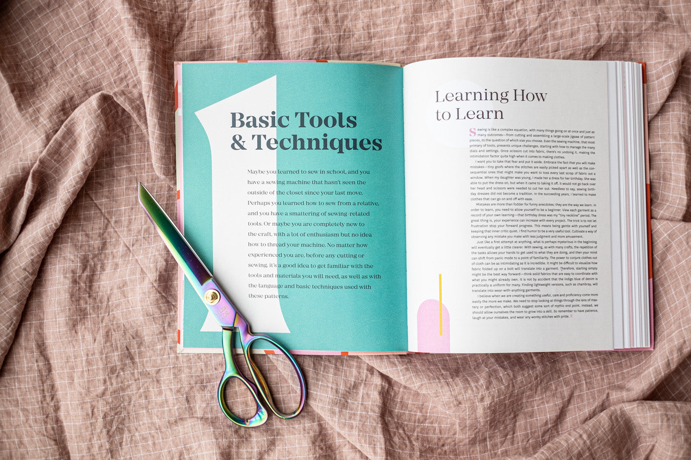 The book open to the first chapter, Basic Tools and Techniques, and a pair of scissors