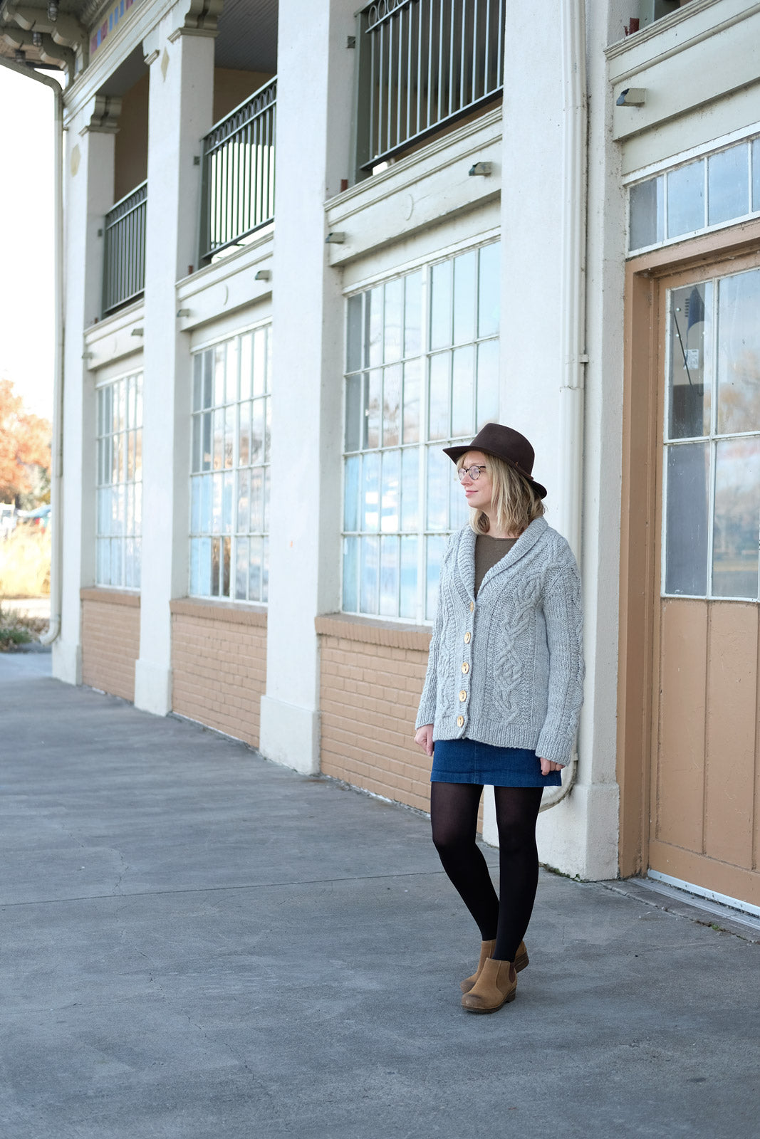 Amber standing by the boathouse in her oversized Sourcebook Cabled Cardigan