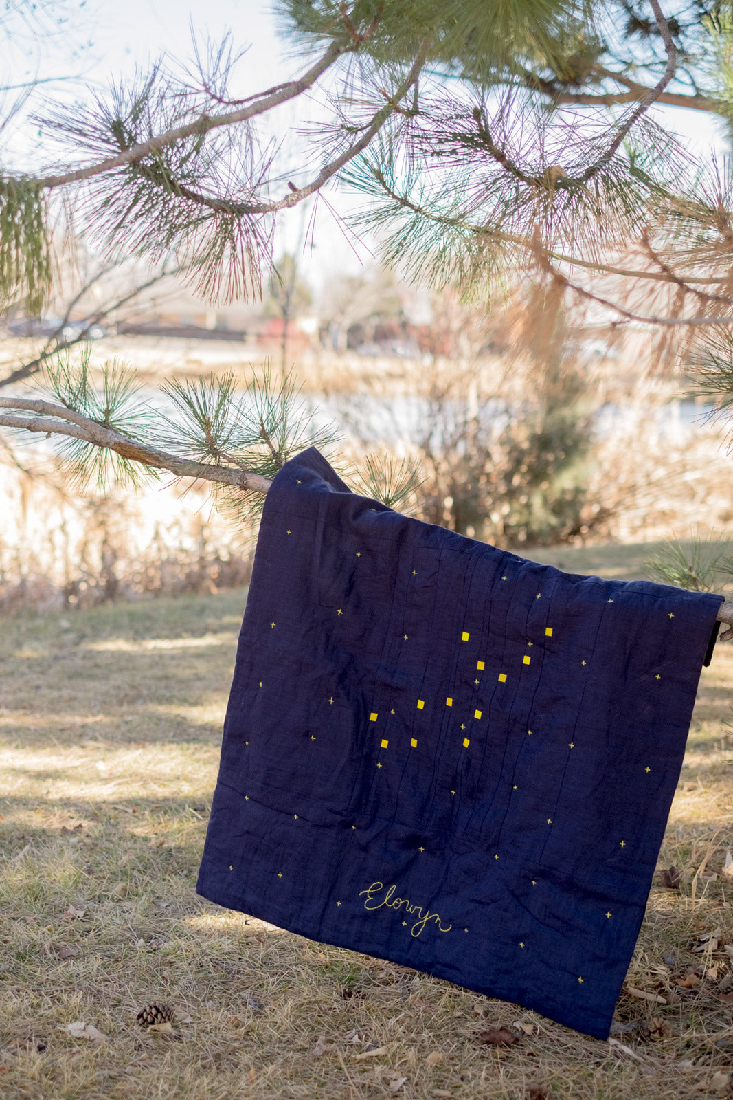 Constellation Baby Quilt hanging from a tree