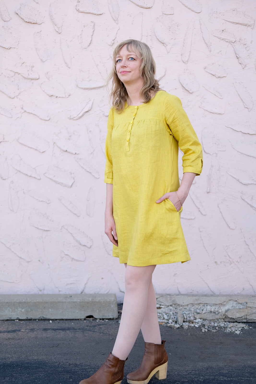 Amber in her citrus colored linen Brome with her hand in the pocket