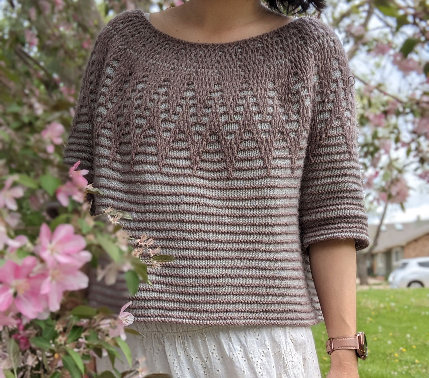 This is a close up shot of Connie's Aubade sweater. Branches from the cherry tree surrounds her.